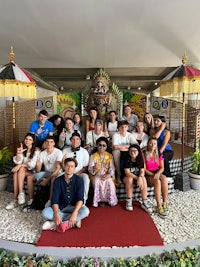 a group of people posing for a photo in front of a temple