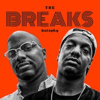 the breaks with kittypip and two men standing in front of an orange background