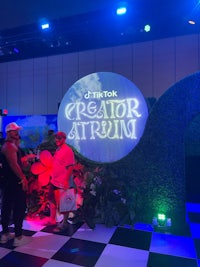 a group of people standing in front of a sign that says creator atlantis