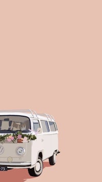 a white vw bus with flowers on it