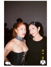 two women standing next to each other at an event