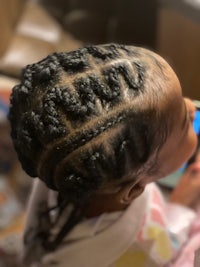 a little girl with braids in her hair