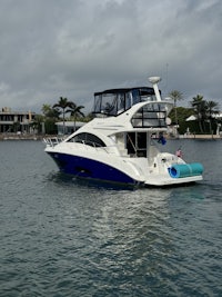 a blue and white motor boat is docked in the water