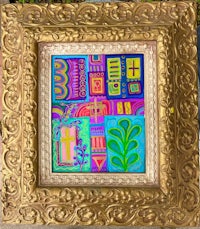 a gold frame with a colorful painting on it