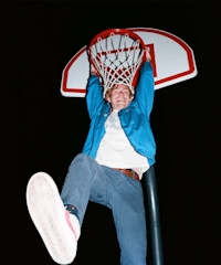 a man jumping into a basketball hoop