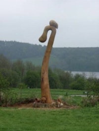 a large wooden sculpture in the middle of a field