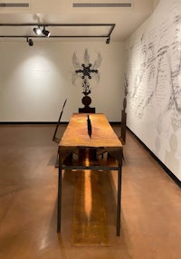 a room with a table and a drawing on the wall