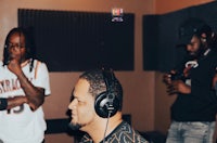 a group of people in a recording studio with headphones on