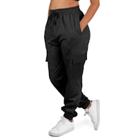 a woman wearing black jogger pants and a white crop top