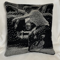 a black and white pillow with a black and white pattern