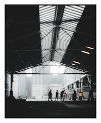 silhouettes of people walking in a warehouse
