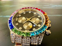 a watch with multi colored crystals on it