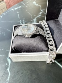 a watch and bracelet in a box on a table