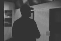 a silhouette of a man standing in a room