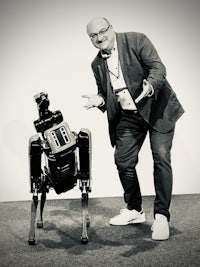a man standing next to a robot