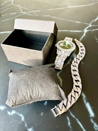 a watch with a box next to it