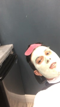 a man wearing a face mask in a bathroom