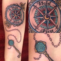 a tattoo of a compass and a key
