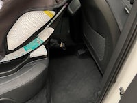 the back seat of a car with a baby seat in it