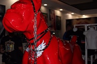 a red statue of a dog with a chain around its neck