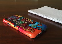 a colorful phone case on a wooden table