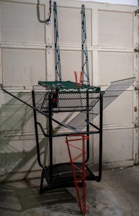 a metal rack in front of a garage