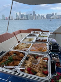 a buffet on a boat with a view of the city