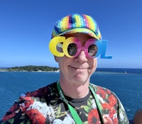 a man wearing colorful sunglasses on a cruise ship