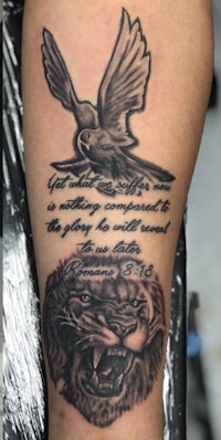 a tattoo with a lion and a bird on it