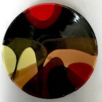 a plate with a black, red, and yellow design