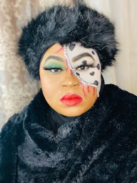 a woman in a fur coat with a cat face makeup