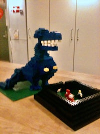 a blue lego dinosaur on a table