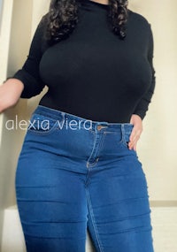 a woman in blue jeans posing for a picture