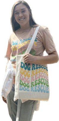 a woman holding a tote bag that says dog rescue