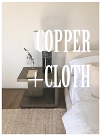 a bed with a bedside table and the words copper + cloth