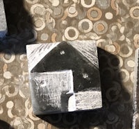 a set of metal blocks with a house on them