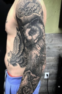 a man with an owl tattoo on his sleeve
