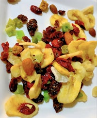 a white plate with fruit and nuts on it