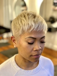 a woman with short blonde hair in a salon