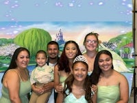 a group of people posing for a photo in front of a fairy backdrop