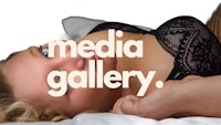 a woman in lingerie laying on a bed with the words media gallery