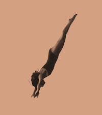 a black and white image of a woman diving
