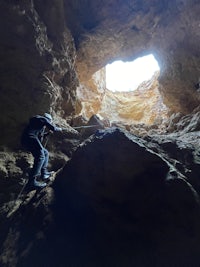 a man is climbing in a cave