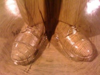 a pair of wooden shoes on top of a wooden table