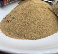 a pile of brown powder on a white plate