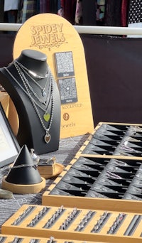 a display of jewelry on a table at an outdoor market