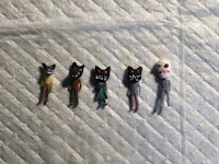 a group of small figurines are lined up on a piece of cloth