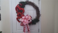 a valentine's day wreath hanging on a door