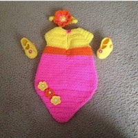 a crocheted outfit with a pink and yellow dress and shoes