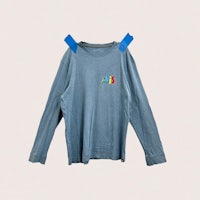 a blue long sleeve t - shirt with tape on it